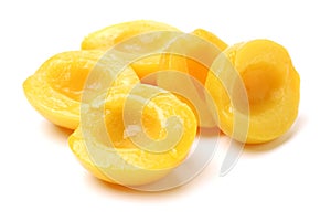 Pile of canned peach fruit`s halves