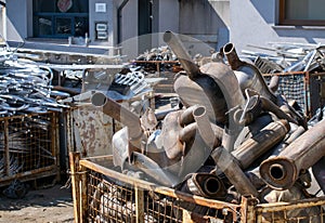 A pile of car mufflers at the junkyard