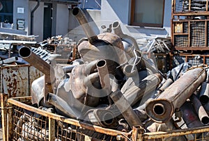 A pile of car mufflers at the junkyard