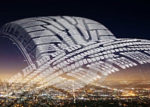 Pile of car tyres on city background