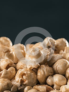 Pile of caramel corn on black background