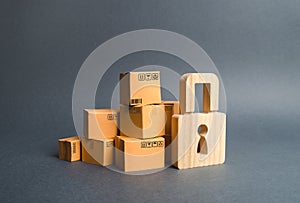 A pile of cardboard boxes and a wooden padlock. concept of insurance purchases. Providing warranty on purchased products. Consumer