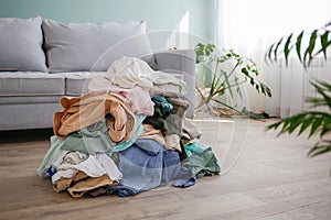 Pile of carelessly scattered clothes on floor