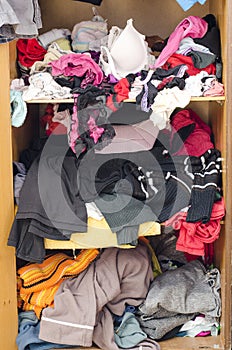 Pile of carelessly scattered clothes in wardrobe photo