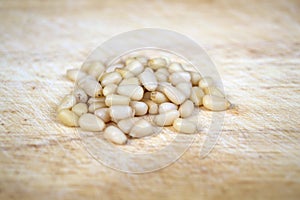 Pile of cedar nuts on a wooden surface