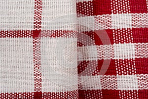 Pile of checkered fabric closeup kitchen towels folded on background, macro flat lay image