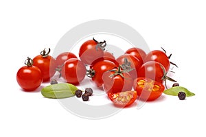 Pile of cherry tomatoes with spice on white background close up