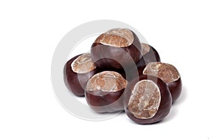 A pile of chestnuts, conkers isolated on white background, closeup