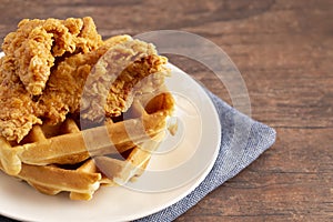 Pile of Chicken and Waffles on a Rustic Wooden Counter