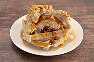 Pile of Chicken and Waffles on a Rustic Wooden Counter