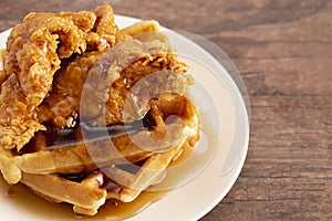 Pile of Chicken and Waffles on a Rustic Wooden Counter
