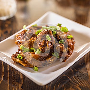 Pile of chicken wings on plate.