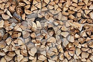 Pile of chopped birch firewood in remote Russian village