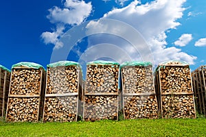 Pile of Chopped Firewood on Blue Sky