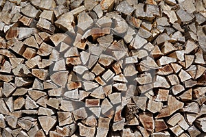 Pile of chopped wood trunk pieces. Old weathered timber background. Lumber backdrop.