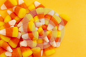 A Pile of Classic Candy Corn on Yellow Orange Background