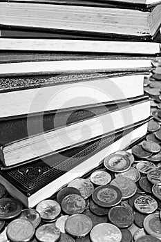 Pile of classics books surrounded with coins [Black and White version]