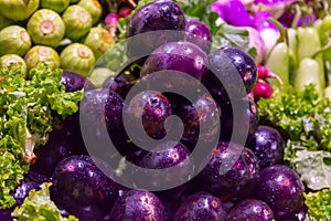 Pile of clean and fresh purple eggplants in the market