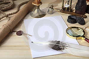 A pile of clean paper, a retro inkwell with black ink, a goose feather, magnifying glass, a scroll with a seal, an old hourglass a