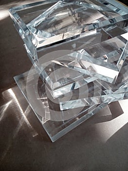 a pile of clear glass acrylic pieces on a table