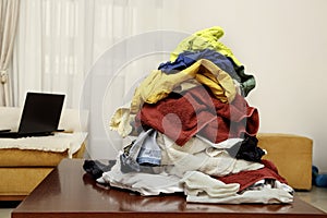 pile of clothes on coffee table