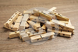 Pile of clothes pins on wooden table, closeup