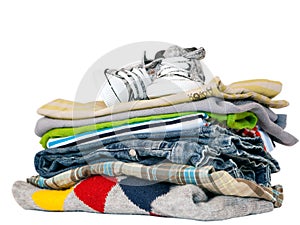 Pile of clothes and sneakers isolated on white