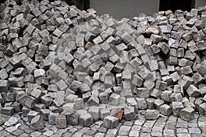 Pile of cobblestones on a pavement, a construction background