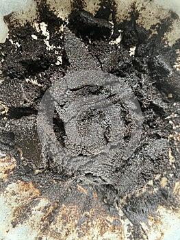 Pile of coffee grounds on white coffee filter