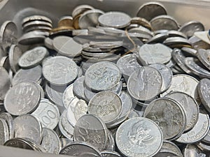 a pile of coins that are being calculated from savings