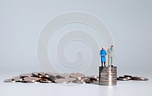 A pile of coins and miniature people.