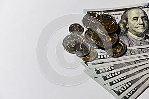 A pile of coins and a stack of dollar bills