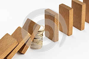 Pile of coins Stopping Falling wooden Dominoes effect