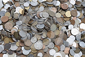 A pile of coins of various sizes and colors