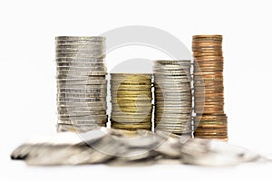 Pile of coins in white background close-up arranged in a row