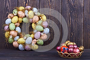 Pile of colored decorative eggs on dark wood.