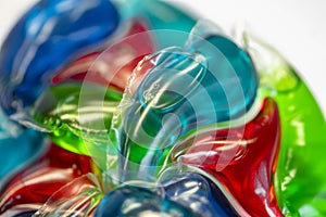 Pile of colored laundry detergent capsules, close-up, selective focus.