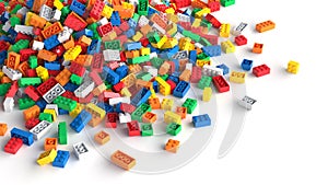 Pile of colored toy bricks on white background.
