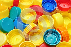 Pile of colorful bottle caps background. Used PET recycling plastic bottle cap plastic lids. Garbage PET waste recycling