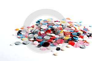 A pile of colorful buttons on a white background.