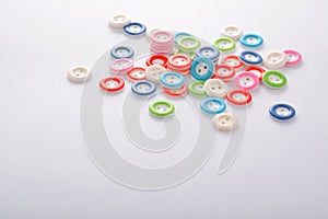 Pile of colorful buttons on white background