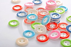 Pile of colorful buttons on white background