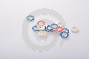 Pile of colorful buttons on white background