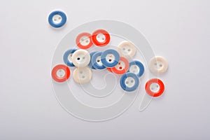 Pile of colorful buttons on white background