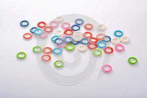 Pile of colorful buttons on white background