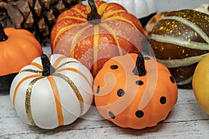Pile of colorful decorative pumpkins in orange, black, and white
