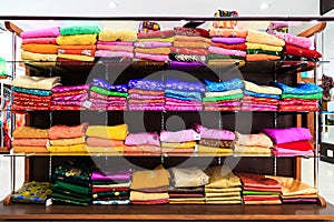 Pile of colorful fabrics on shelves