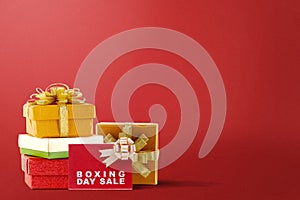Pile of colorful gift box with ribbon and Boxing Day Sale text