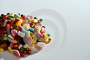 Pile of colorful jelly sweets made from fruit juice, gelatin and sugar isolated over white background