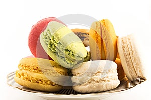 A Pile of Colorful Macaroons on a Plate Isolated on White Background